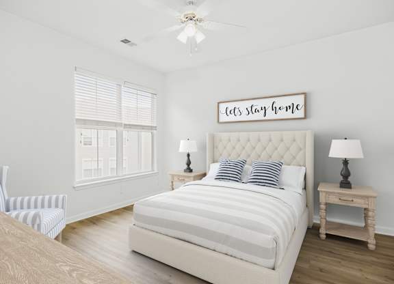 A bedroom with a large bed and a sign that says