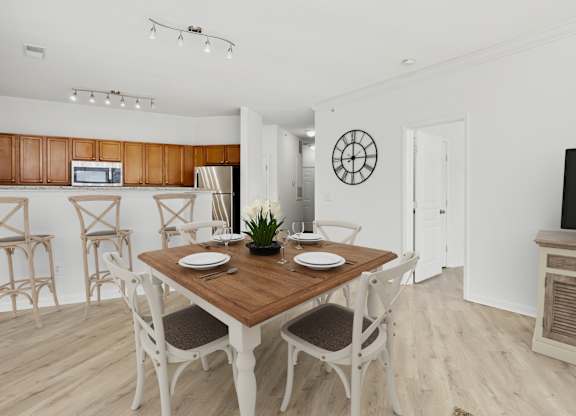 A dining room with a wooden table and chairs.