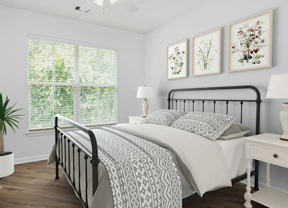 A bedroom with a large bed and a window with blinds.