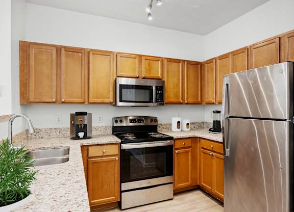 A kitchen with wooden cabinets and stainless steel appliances.