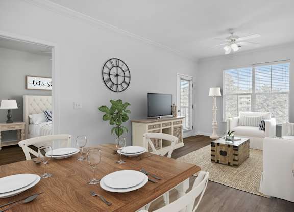 A dining room with a wooden table set for two.