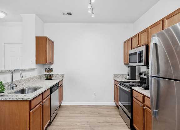 A kitchen with wooden cabinets and stainless steel appliances.