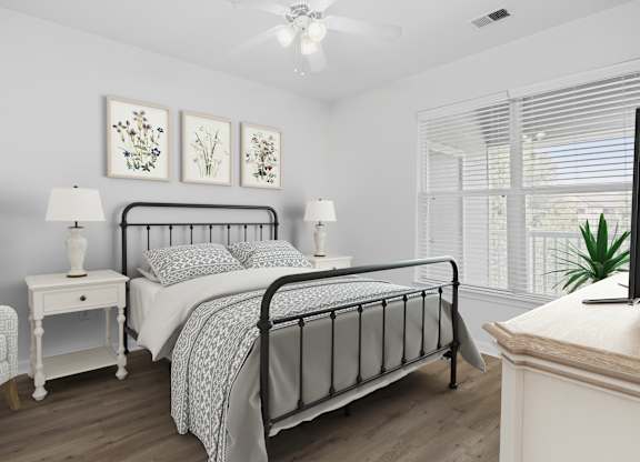A bedroom with a large bed, a chair, a nightstand, and a painting on the wall.