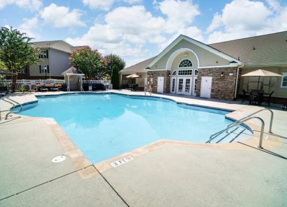 A swimming pool with a building in the background.