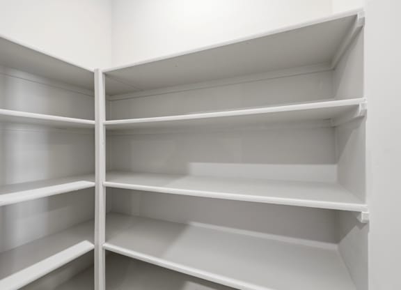 Empty white shelves in a room.
