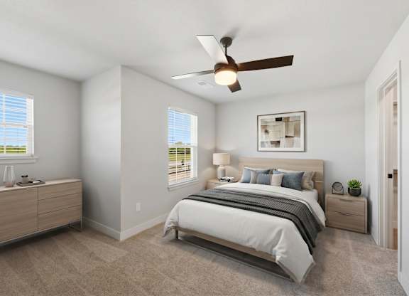 A bedroom with a bed, nightstand, and a ceiling fan.