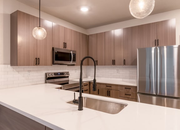 Townhouses For Rent In Raymore - Designer Kitchens With Island, Pantry, Quartz Countertops, Stainless Steel Samsung Appliances, Built-In Microwave, And Soft Close Cabinetry.