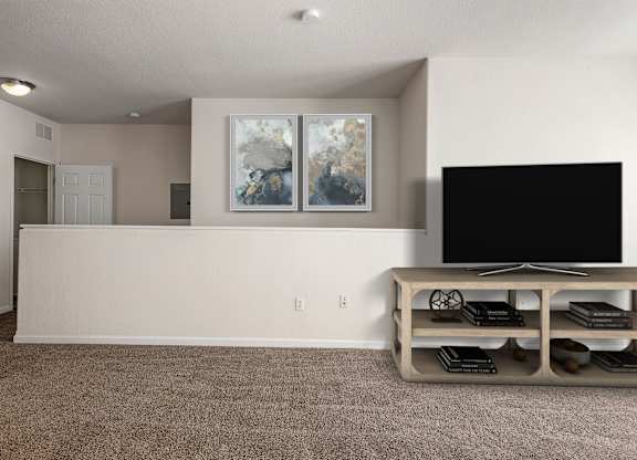 A living room with a television and a painting on the wall.
