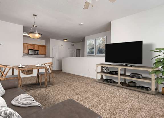 A living room with a grey couch and a wooden table.