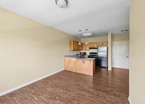 A kitchen with a wooden island and a refrigerator.