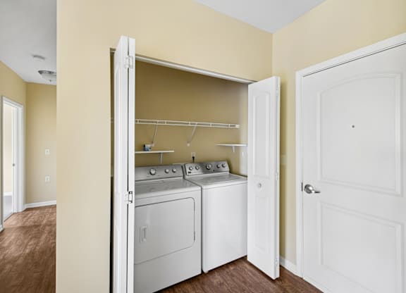 A small laundry room with a washer and dryer.