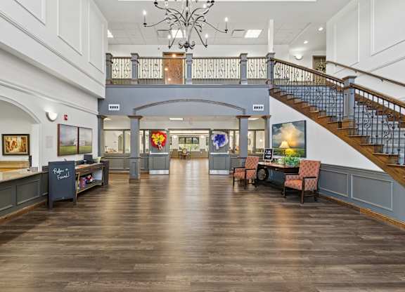 A large room with a staircase and a chandelier.