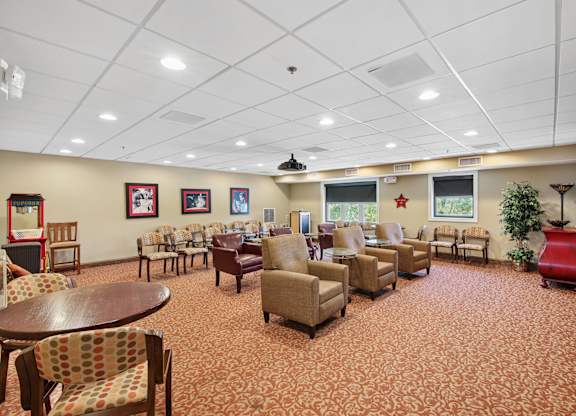 A living room with a patterned carpet and furniture.