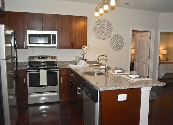 A kitchen with a stove top oven and a microwave.