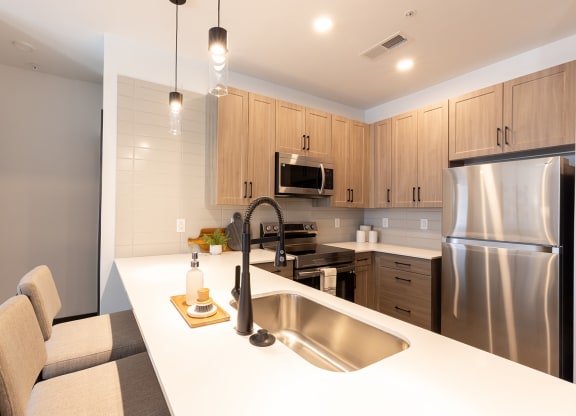 a kitchen with wooden cabinets and a white counter top