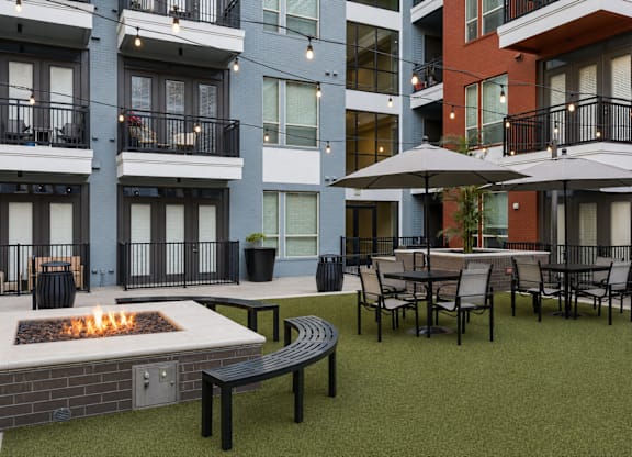 A patio with a fire pit and chairs at L2 Uptown in Dallas Texas.