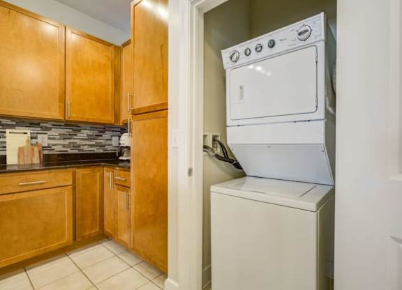 A white oven is built into a wall in a kitchen.
