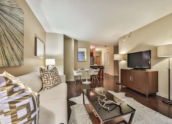 A living room with a white couch and a television.
