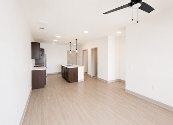 A room with a ceiling fan and lighting fixtures.
