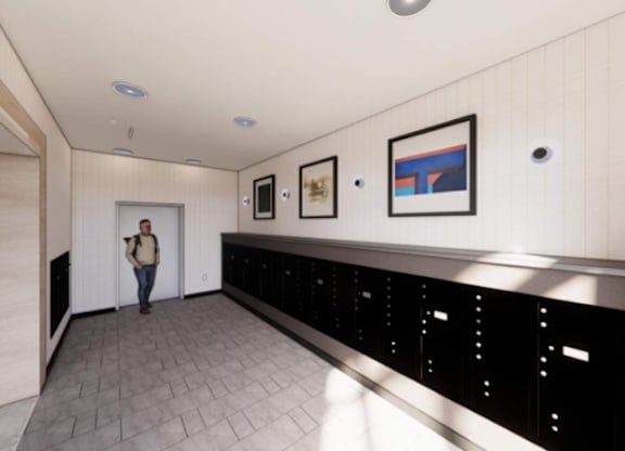 A woman is standing in a hallway with a black counter on the wall.