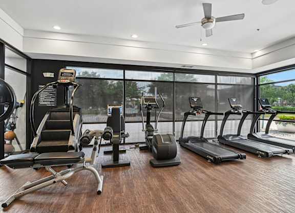 Markethaus 3700 Plano Texas A gym with treadmills, elliptical machines, and a weight bench.