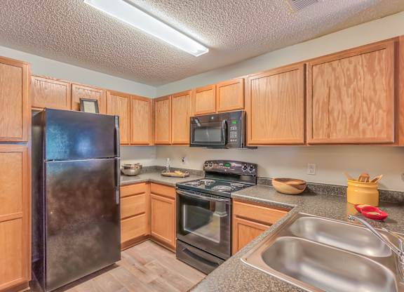 A kitchen with wooden cabinets and stainless steel appliances.