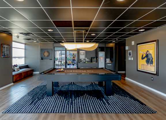 A modern living room with a black and white striped rug.