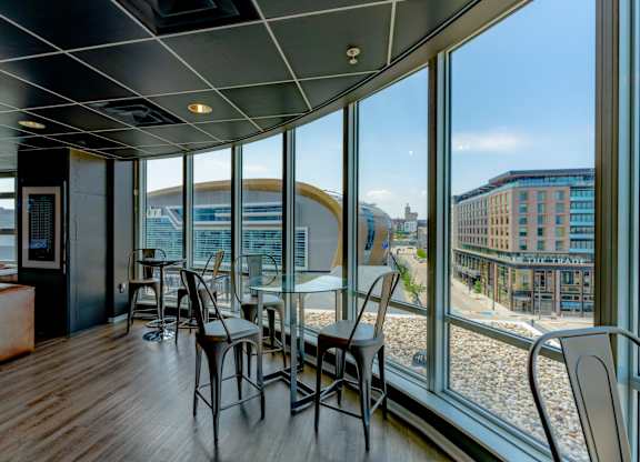 A room with a table and chairs with a view of the outside.