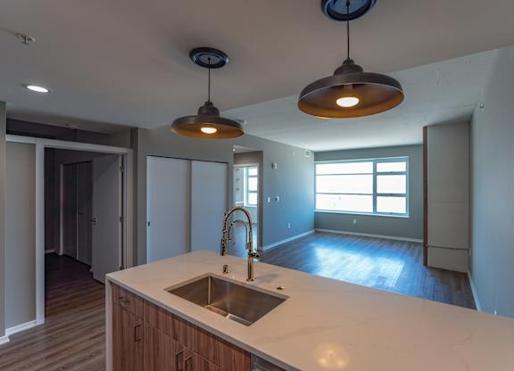 A kitchen with a sink and a window.