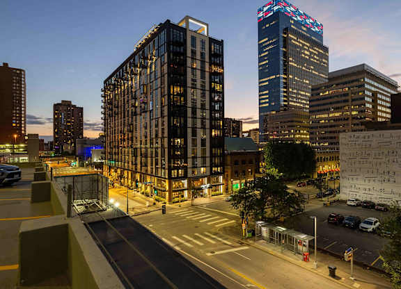 A night view of a city with Artistry on 10th at the center