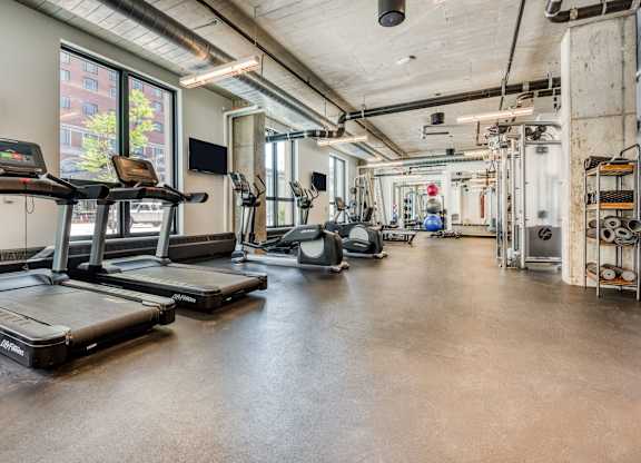 the gym with treadmills and weights at the belgard apartments