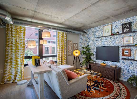 a living room with blue and yellow wallpaper and a couch