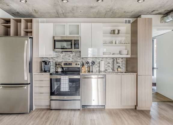 a kitchen with stainless steel appliances and white cabinets