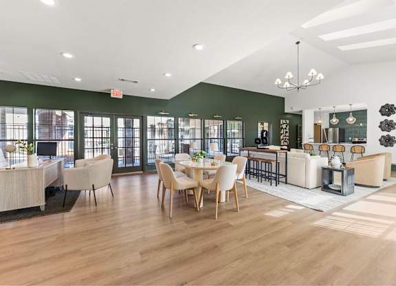 A spacious room with wooden floors and furniture.