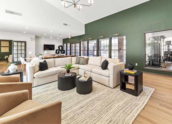 A living room with a white couch, a coffee table, and a rug.