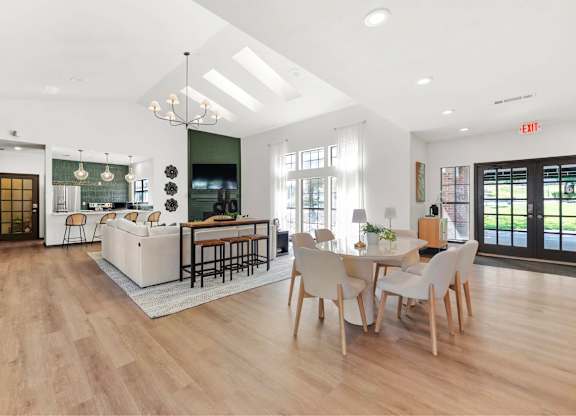 A modern kitchen with a dining table and chairs.