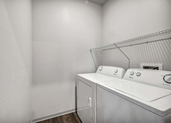 a washer and dryer in a laundry room with white walls