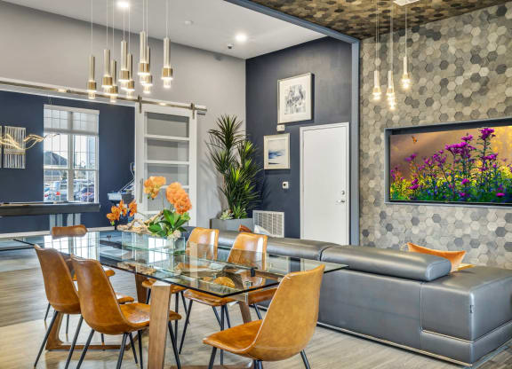 a dining room with a glass table and a couch