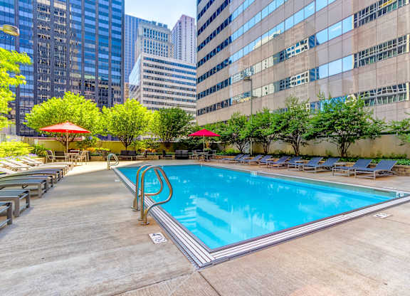 a swimming pool in the middle of a city skyscraper