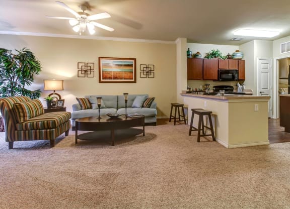 a living room and kitchen with a couch and a table
