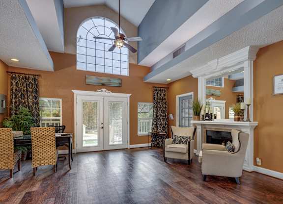 A living room with a fireplace and a dining table.