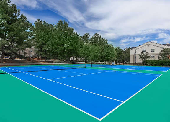 Waters Edge at Harbison's community tennis court surrounded by trees 
