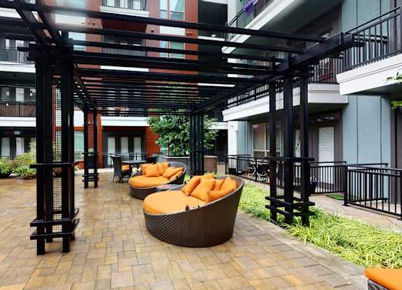 A patio with black railings and a black metal structure.