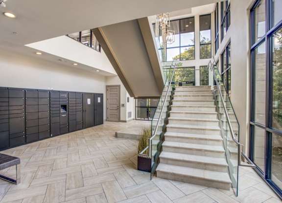 A modern house interior with a staircase leading to the upper floor.