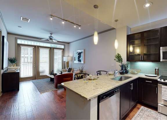 A modern kitchen with dark wood cabinets and stainless steel appliances.