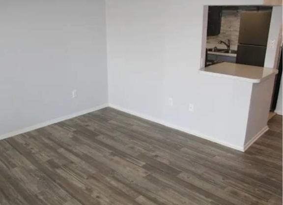 A room with a wooden floor and white walls.