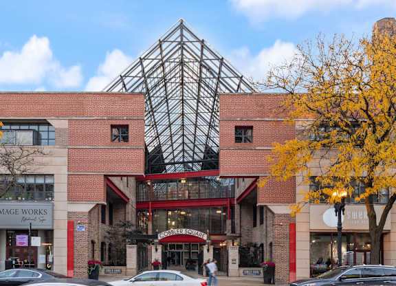 A large building with a glass pyramid in the middle of it.