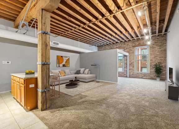 A living room with a wooden beam ceiling and a couch.