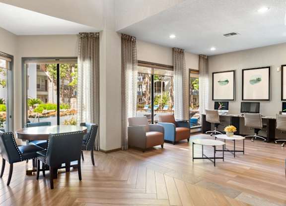A modern living room with a dining table and chairs.