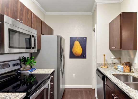 A kitchen with a black stove top oven and a black microwave.